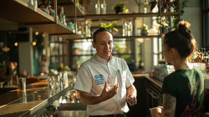 An Ecolab associate talking with a customer at a restaurant.