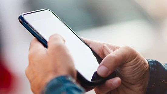 Person Holding Stack of Plates in Commercial Kitchen