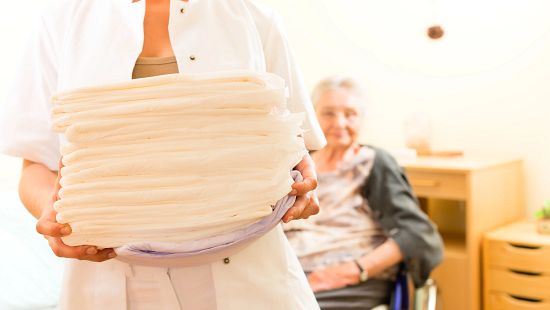 Person holding stack of linens